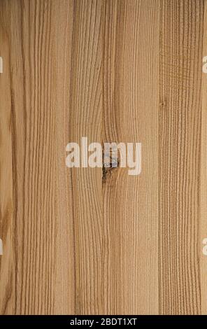 The texture of the wood. The background is pinkish. There are scratches and knots in the center of the wooden board. Stock Photo