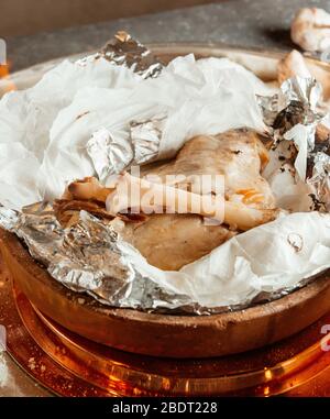 close up of lamb meat in pottery pan cooked in salt crust Stock Photo