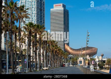 Mapfre tower and seafront promenade in Barceloneta Barcelona is practically deserted due to the total confinement of the population in Spain. Spain is Stock Photo