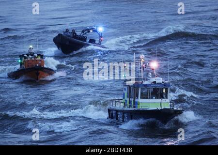 Members of Metropolitan Police, RNLI and London Fire Brigade on the River Thames near St Thomas' Hospital in Westminster, London, to salute local heroes during Thursday's nationwide Clap for Carers NHS initiative to applaud NHS workers fighting the coronavirus pandemic. Stock Photo
