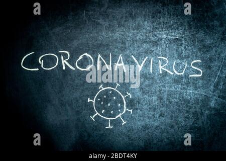 Coronavirus, drawn text with chalk on blackboard. School concept. Stock Photo