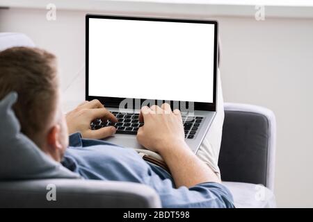 Cropped Image Of Young Man Using Laptop At Home Stock Photo
