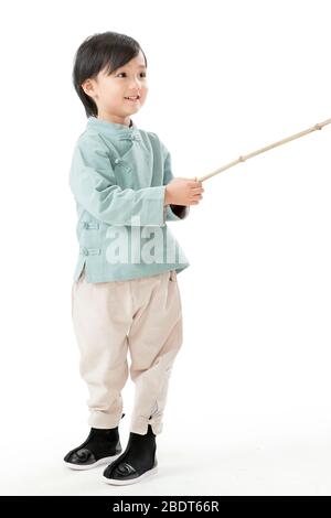 A little boy holding a lantern pole Stock Photo