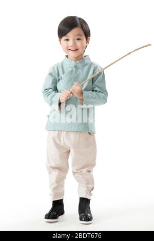 A little boy holding a lantern pole Stock Photo