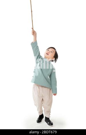 A little boy holding a lantern pole Stock Photo