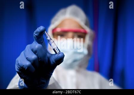 Doctor researcher with ampoule serum vaccine for vaccination inoculation health care science research Stock Photo