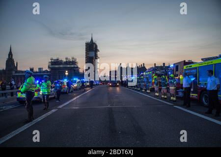 Westminster, London, UK. 9th April 2020. Police, firefighters and other members of the public cheered for NHS staff on Westminster Bridge. Credit: Marcin Nowak/Alamy Live News Stock Photo