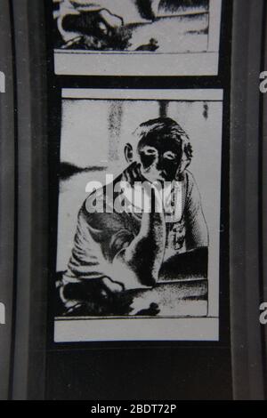 Fine 1970s extreme black and white photography of a regular guy sitting while relaxed and looking at the camera Stock Photo