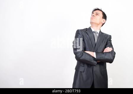 Arrogant man in suit. White background, Medium shot Stock Photo