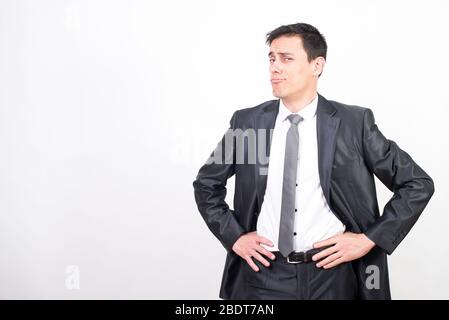 Arrogant man in suit. White background, Medium shot Stock Photo