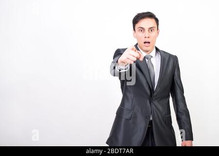 Man in suit pointing in front with index finger. White background, Medium shot Stock Photo
