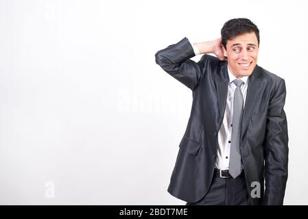 Shy man in suit. White background, Medium shot Stock Photo