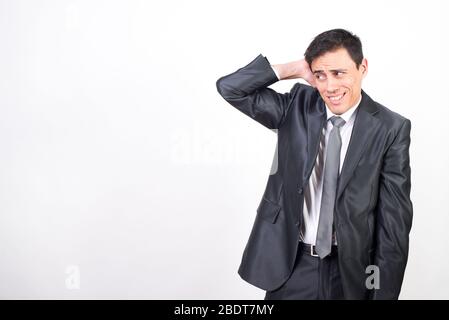 Shy man in suit. White background, Medium shot Stock Photo
