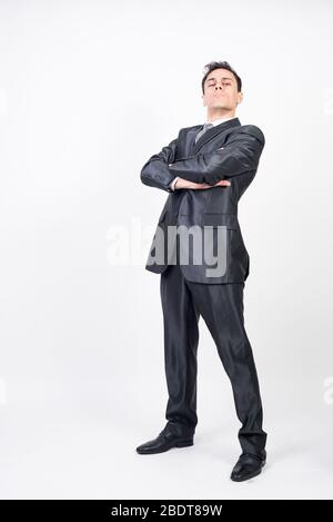 Man in suit pointing in front with index finger. White background, full body Stock Photo