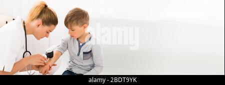 Dermatologist Doctor Checking Child Skin For Allergy And Melanoma Stock Photo