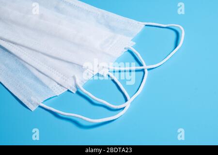 Surgical mask, surgical masks on isolated blue surface Stock Photo