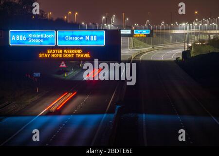 Glasgow, UK. 9th Apr, 2020. Pictured: Road signs all along the M8 and M80 motorways which read, “EASTER WEEKEND STAY HOME DONT TRAVEL” The Coronavirus Pandemic has forced the UK Government to order a shut down of all the UK major cities and make people stay at home, which has left the motorways and all other roads free of the usual nose to tail traffic which would otherwise be there. Credit: Colin Fisher/Alamy Live News Stock Photo