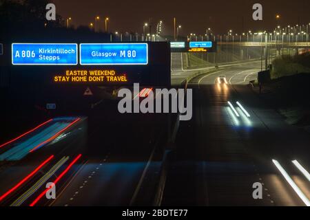 Glasgow, UK. 9th Apr, 2020. Pictured: Road signs all along the M8 and M80 motorways which read, “EASTER WEEKEND STAY HOME DONT TRAVEL” The Coronavirus Pandemic has forced the UK Government to order a shut down of all the UK major cities and make people stay at home, which has left the motorways and all other roads free of the usual nose to tail traffic which would otherwise be there. Credit: Colin Fisher/Alamy Live News Stock Photo