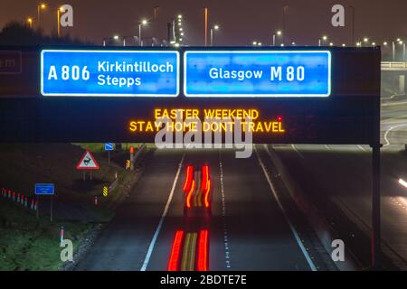 Glasgow, UK. 9th Apr, 2020. Pictured: Road signs all along the M8 and M80 motorways which read, “EASTER WEEKEND STAY HOME DONT TRAVEL” The Coronavirus Pandemic has forced the UK Government to order a shut down of all the UK major cities and make people stay at home, which has left the motorways and all other roads free of the usual nose to tail traffic which would otherwise be there. Credit: Colin Fisher/Alamy Live News Stock Photo