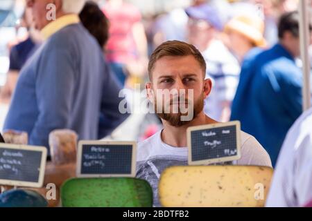 Man with cheese at the Menerbes market, Provence, France Stock Photo