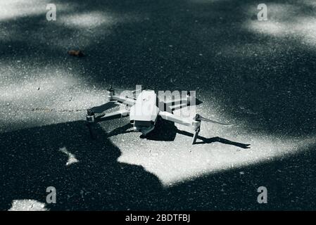 The drone is off lying on the ground. Landing the drone on the ground. Grey copter in assembled ready condition Stock Photo