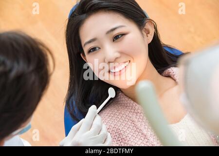 The dentist gave young female patients Stock Photo