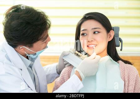 The dentist gave young female patients Stock Photo