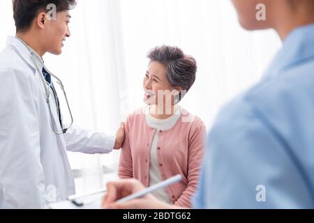 The doctor talked with elderly patients Stock Photo