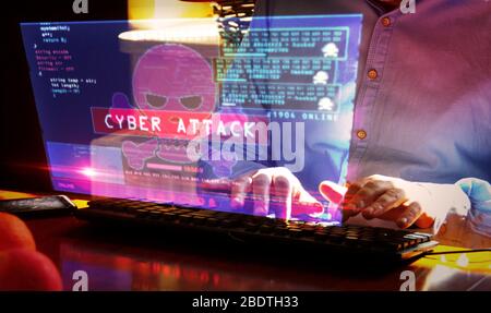 Hacker typing on the keyboard and breaks computer security on virtual hologram screen on desk. Cyber attack, cybercrime, piracy, digital safety and id Stock Photo