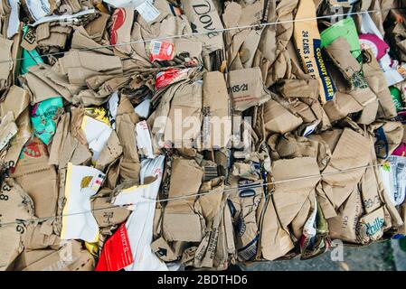 usa, miami - april, 2020 Stack of pressed corrugated cardboards ready for recycling Stock Photo