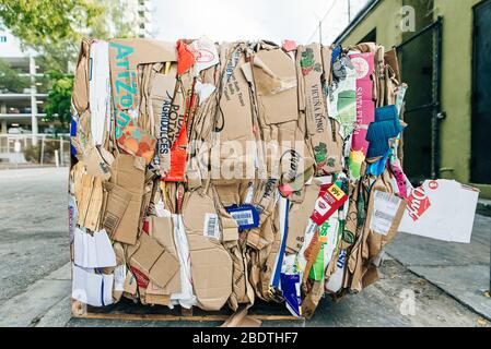 usa, miami - april, 2020 Stack of pressed corrugated cardboards ready for recycling Stock Photo