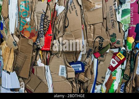usa, miami - april, 2020 Stack of pressed corrugated cardboards ready for recycling Stock Photo