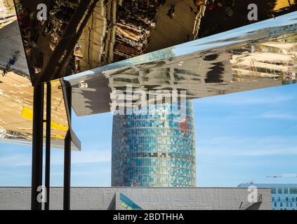 Reflection in mirrored roof of the Encants Vells Flea Market, with the Agbar Tower in the background, Barcelona Spain. Stock Photo