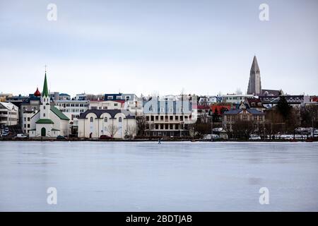 Tjornin Lake frozen over in winter in Reykjavik, Iceland Stock Photo