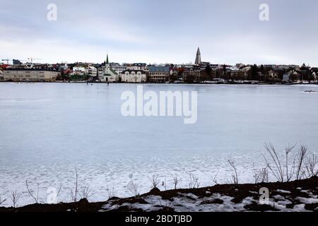 Tjornin Lake frozen over in winter in Reykjavik, Iceland Stock Photo