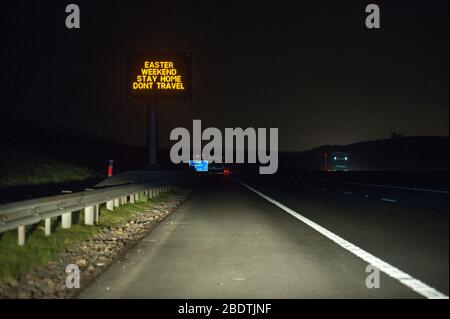 Glasgow, UK. 9th Apr, 2020. Pictured: Road signs all along the M8 and M80 motorways which read, “EASTER WEEKEND STAY HOME DONT TRAVEL” The Coronavirus Pandemic has forced the UK Government to order a shut down of all the UK major cities and make people stay at home, which has left the motorways and all other roads free of the usual nose to tail traffic which would otherwise be there. Credit: Colin Fisher/Alamy Live News Stock Photo