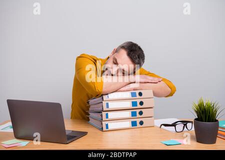 Portrait of marketer banker economist man work home have deadline start-up development project feel overworked sleep on pile stack folders wear trendy Stock Photo