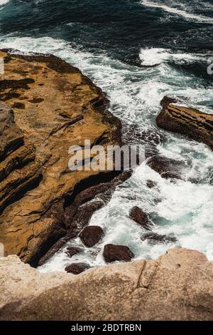 The rocky ocean edge as seen from the Malabar Headland National Park Coastal Walk near Maroubra, New South Wales. Stock Photo