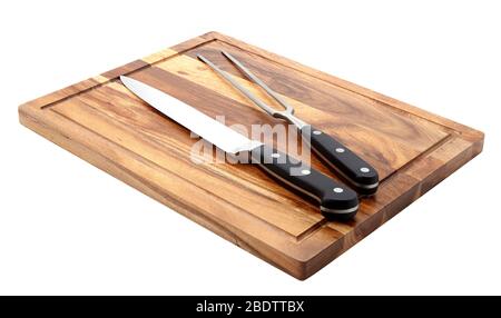 Knife and fork on cutting board Stock Photo