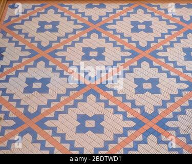 Mosaic pattern typical pavement geometric design in tiles in a Mediterranean town. Stock Photo