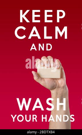 Caucasian male hand holding bar of soap with phrase 'Keep Calm and Wash Your Hands' Stock Photo