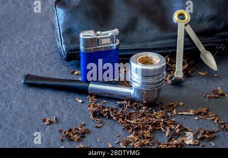 aristo cob on slate with pipe tools and loose tobacco Stock Photo