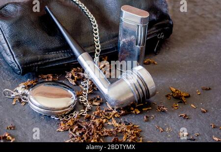 aristocob pipe with leather pouch and accesories, old flint lighter and loose tobacco Stock Photo