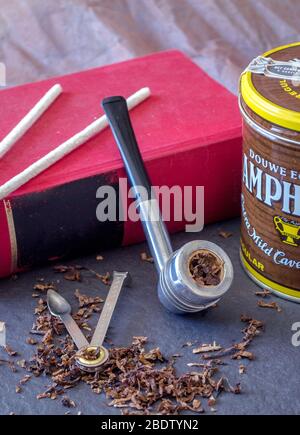 aristocob pipe and tin of tobacco with lose tobacco on slate Stock Photo