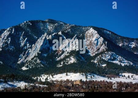 The Flatirons Mountains in Boulder, Colorado on a Snowy Winter Day Stock Photo