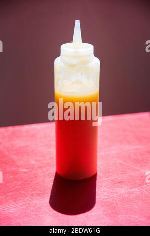 Vertical frame of a plastic squeeze bottle, filled with yellow liquid Stock Photo