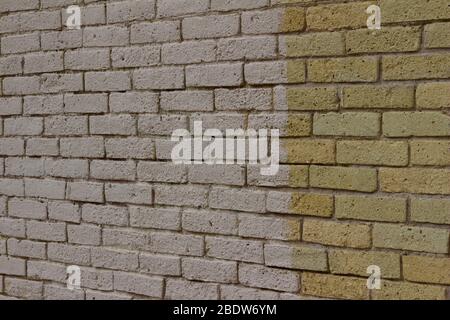 Shabby chic old yellow brick wall texture background, showing a pitted and worn texture from age Stock Photo