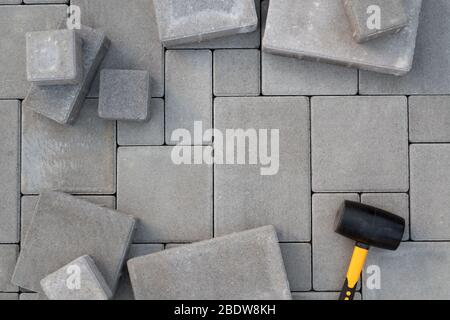 Paving stones paving background. Installing tools on foreground Stock Photo