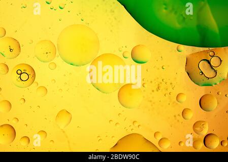 Abstract, image of oil, water and soap in a glass bowl with colourful background Stock Photo
