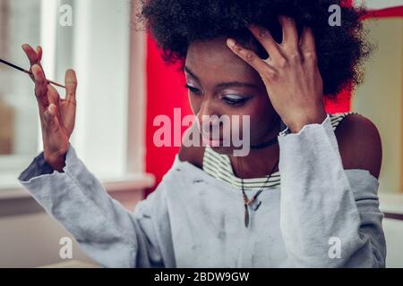 Portrait of serious female that being in thinking process Stock Photo